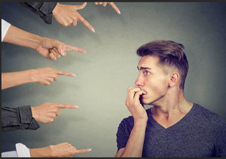 A person looking at a person pointing at another person

Description automatically generated