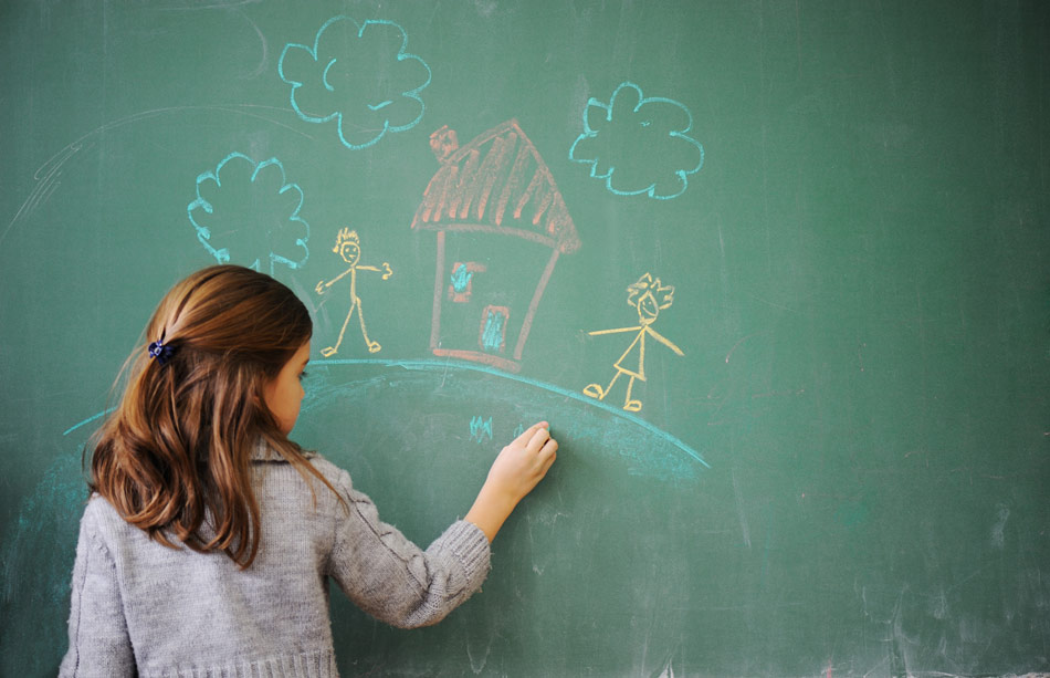 A child drawing on a chalkboard

Description automatically generated