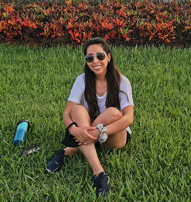 A person sitting in the grass

Description automatically generated